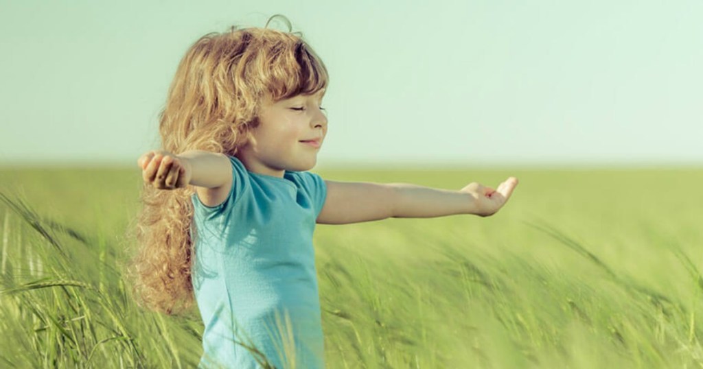 little kid meditating in field