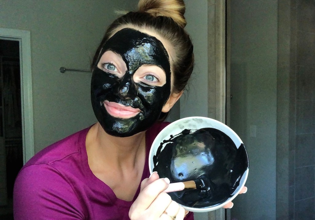 woman wearing black charcoal face mask