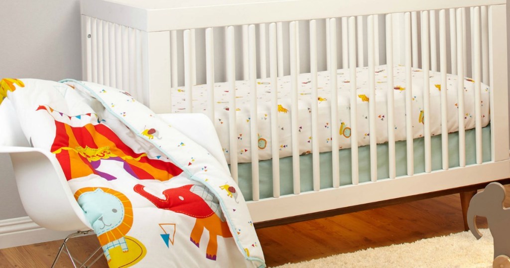 white nursery furniture with circus bedding