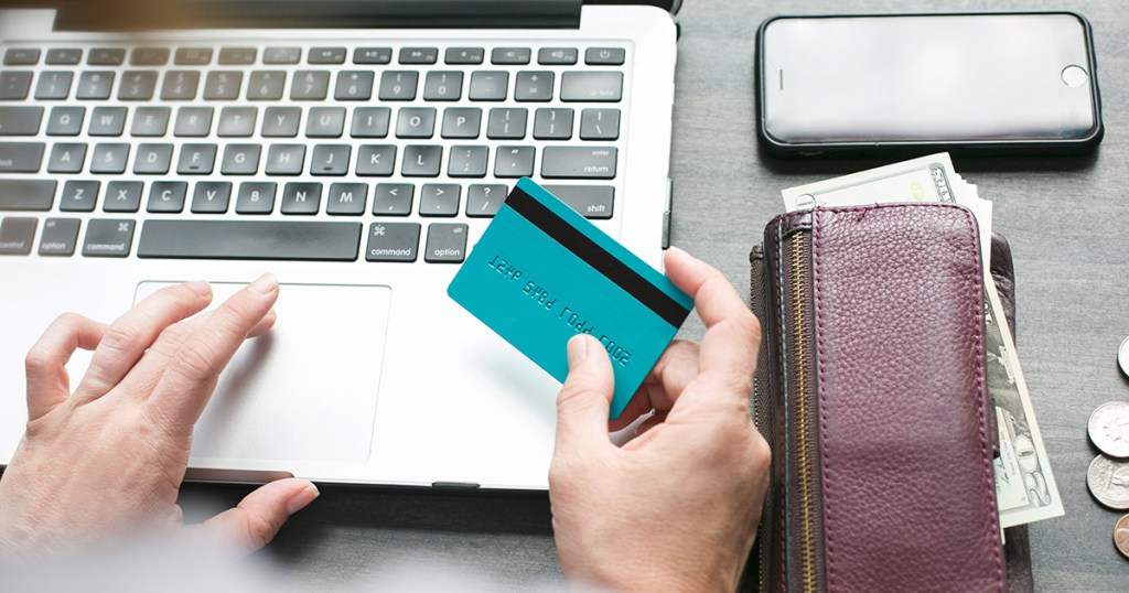 person at computer with credit card