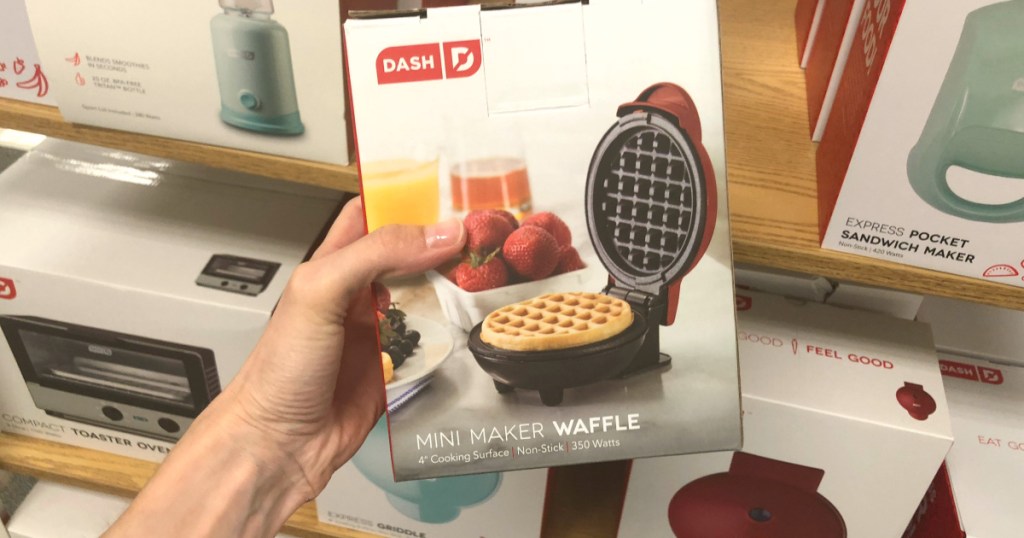 hand next to a dash dash mini waffle maker