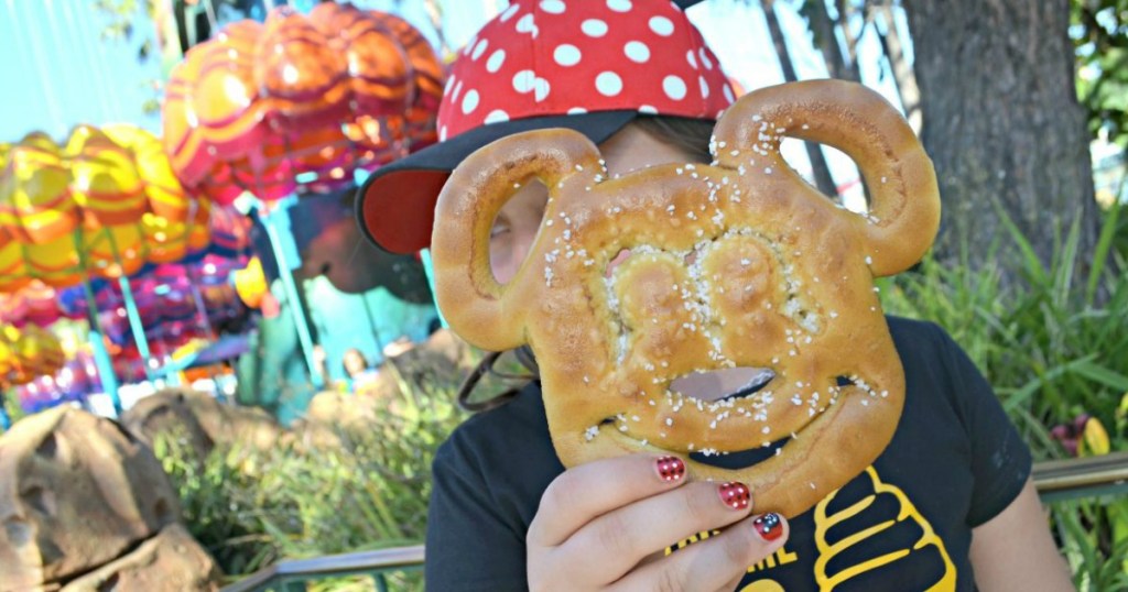 kid holding pretzel shaped like Mickey Mouse