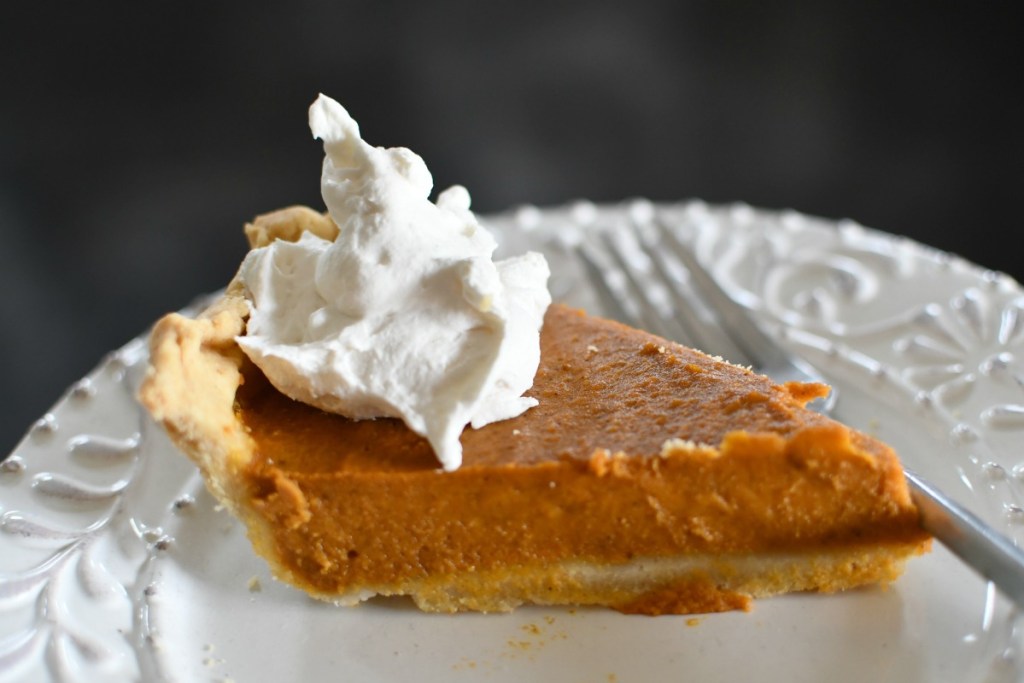 slice of vegan pumpkin pie with vegan tru whip