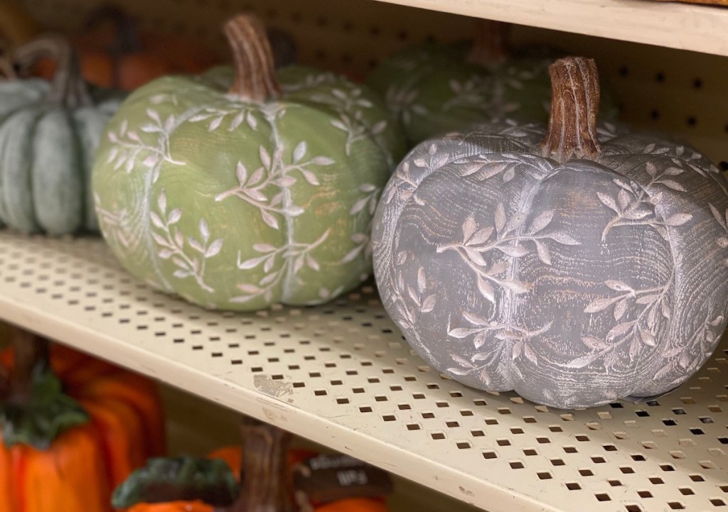 green and gray pumpkins on store shelf