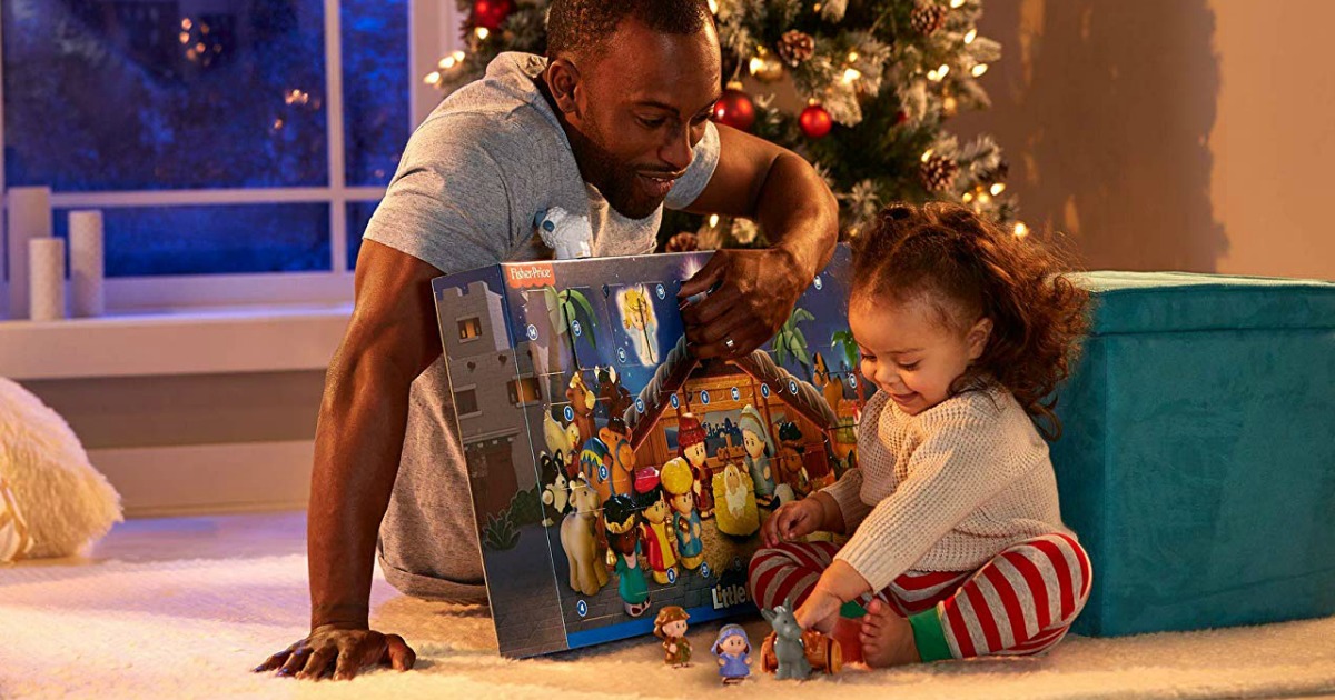 dad and daughter opening Little People advent calendar