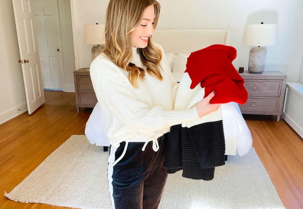 woman holding up colorblock sweater