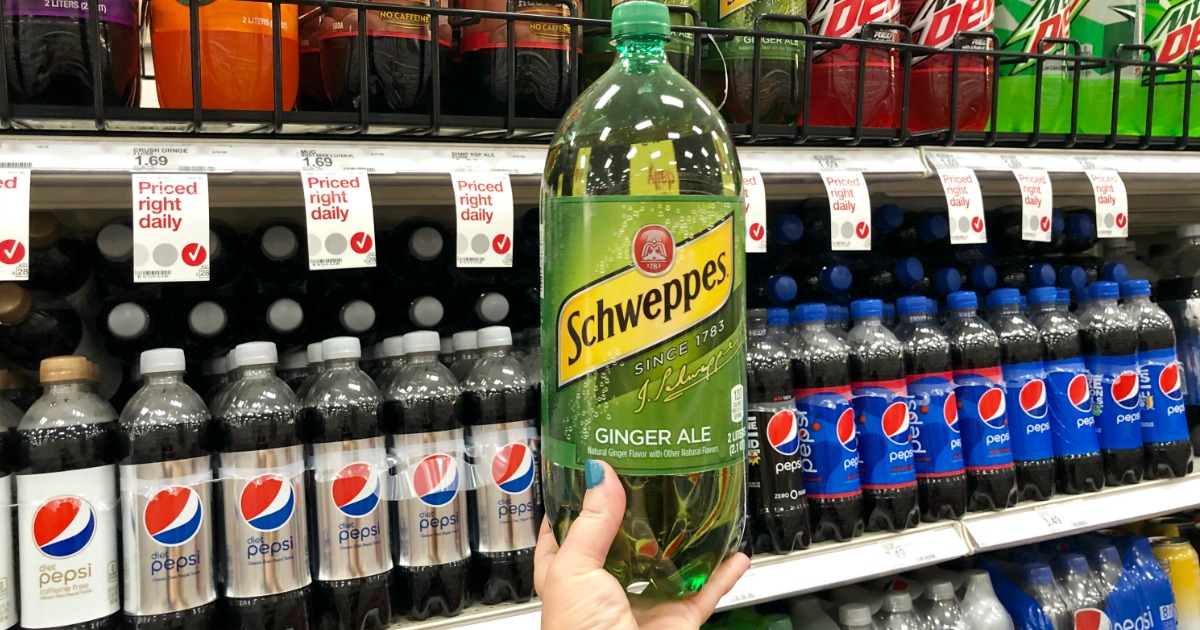 hand holding schweppes 2 liter in store