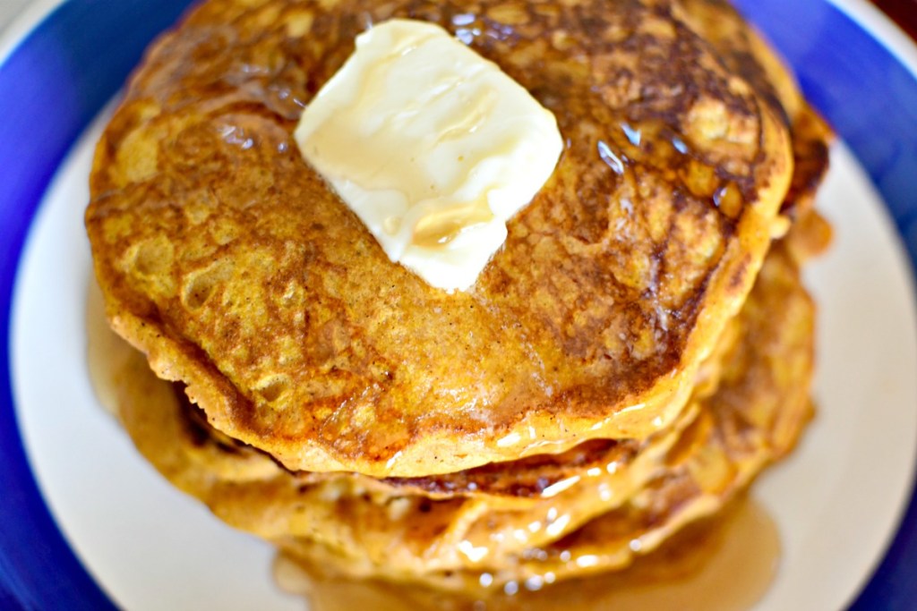 stack of pumpkin pancakes with butter on top