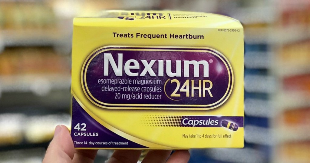 hand holding nexium capsules at target