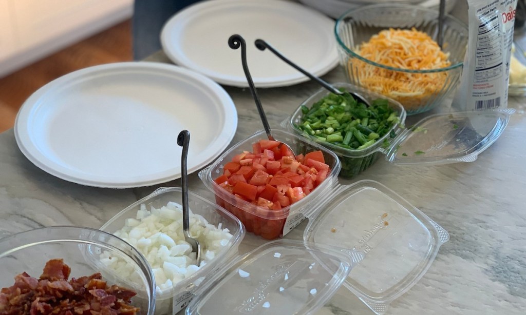 premade packaged veggie toppings sitting on counter with white plates