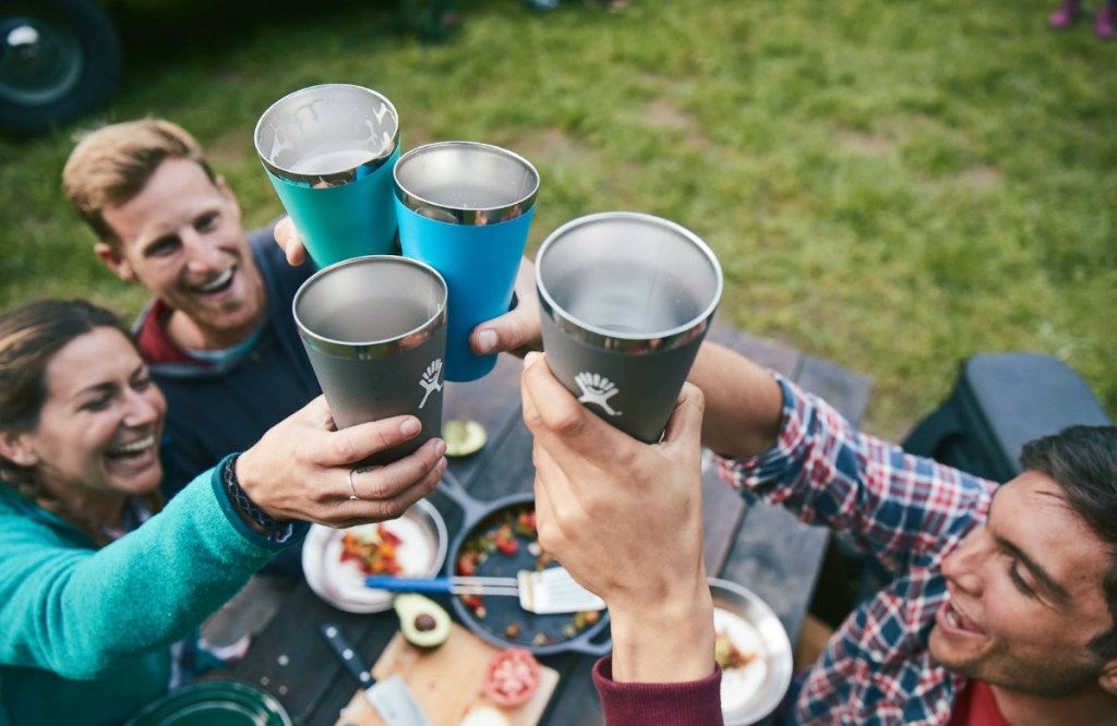 people cheersing their tumblers