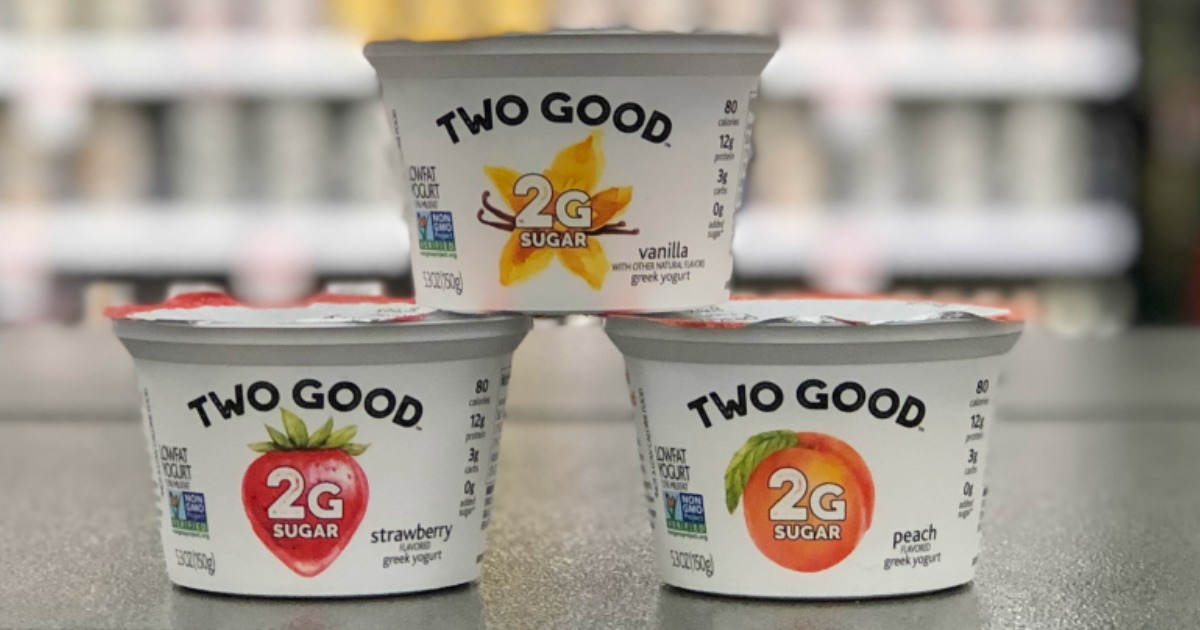 three containers of Two Good yogurt on store table