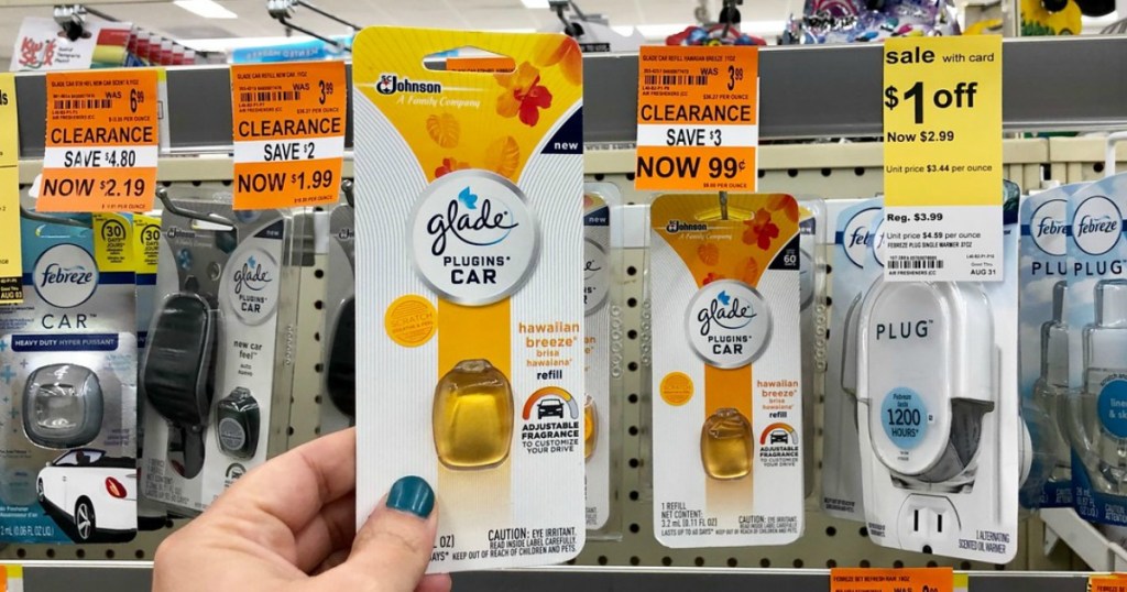 hand holding glade car plugins refills at walgreens