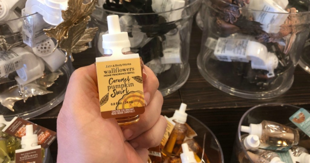 hand holding caramel pumpkin swirl wallflower refill 