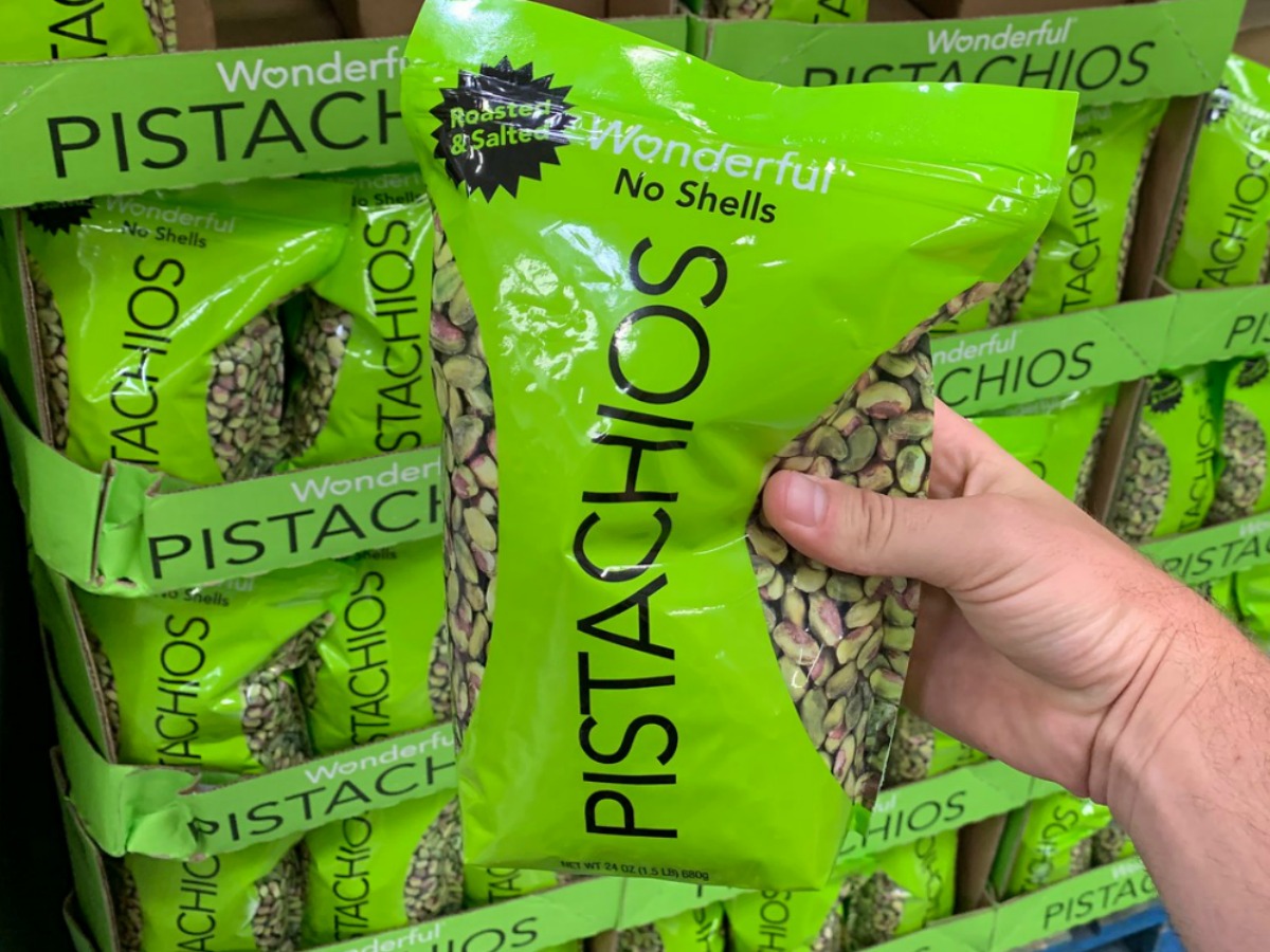 hand holding bag of pistachios in store
