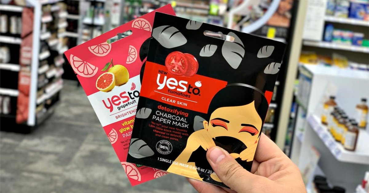 Hand holding two Yes to facial mask products