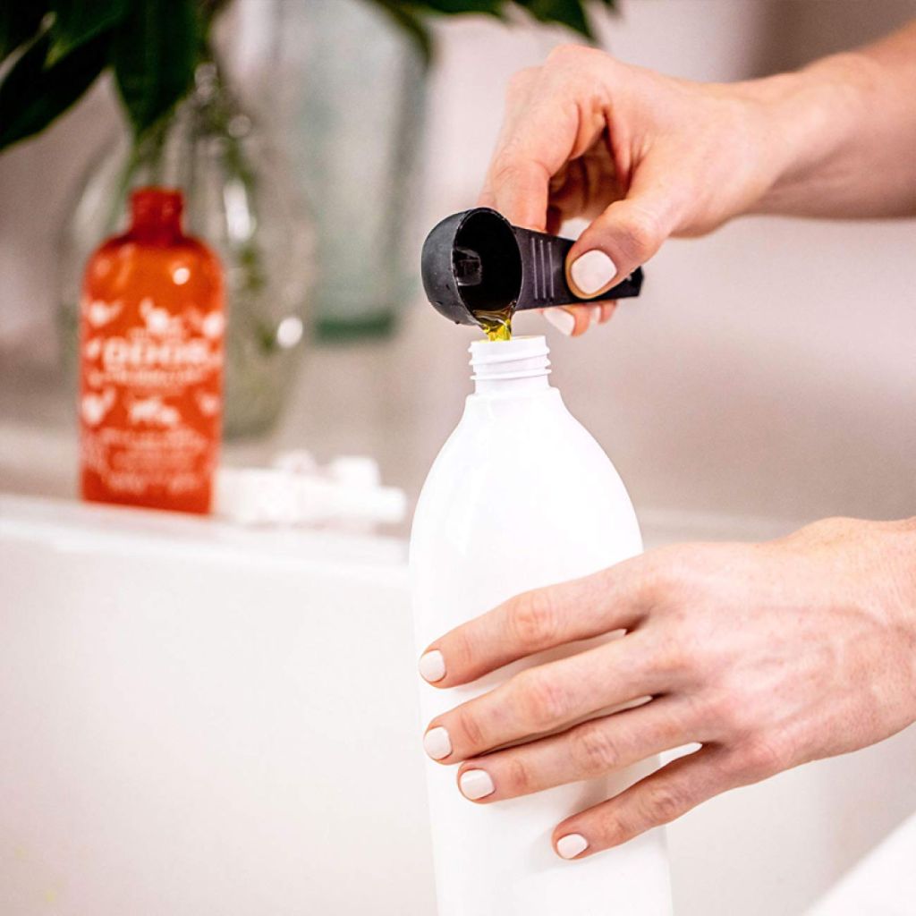 Angry Orange Odor Eliminator Concentrate pouring into bottle