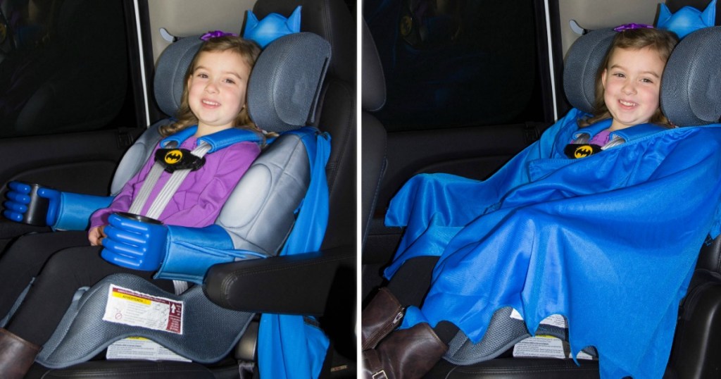 little girl sitting in a Batman Car seat