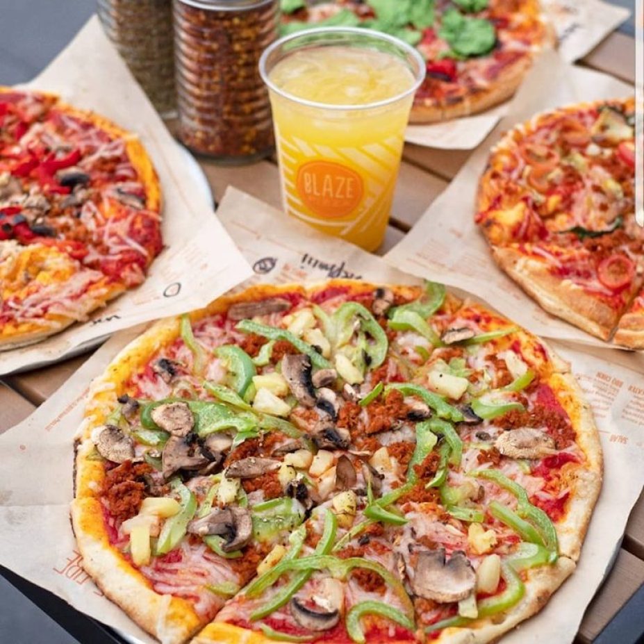 blaze pizza with an orange drink