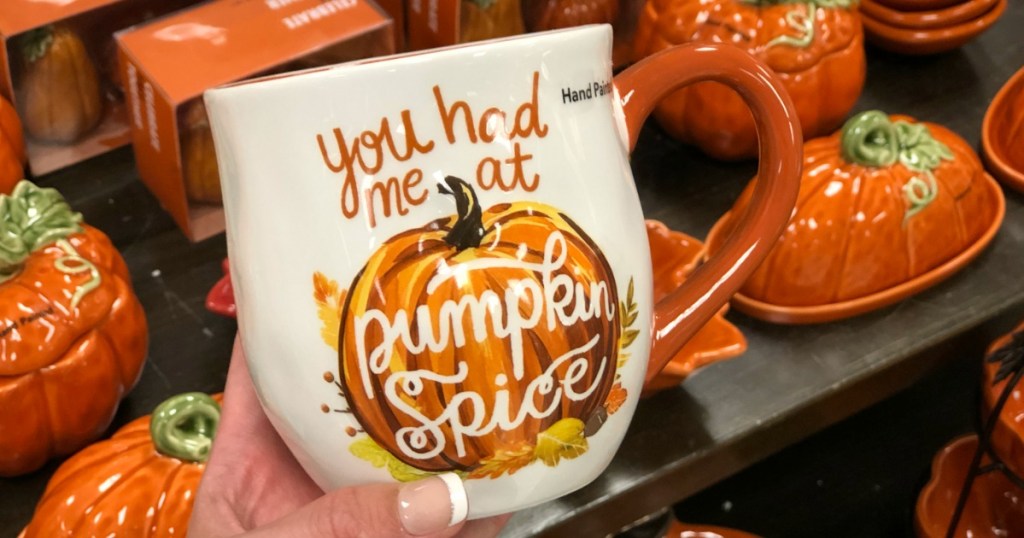 hand holding Celebrate Fall Together Pumpkin Spice Mug