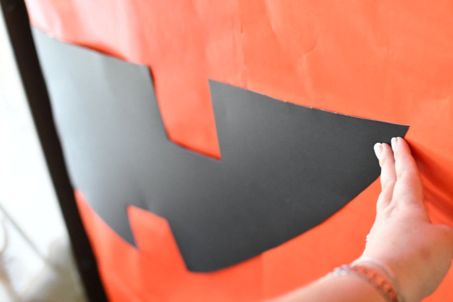 Woman making a DIY Halloween Decoration of a jack-o-lantern