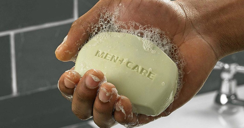 man hand holding soapy Dove Men+Care Extra Fresh Body and Face in bathroom