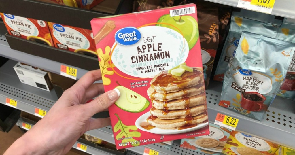 woman holding box of Great Value Apple Cinnamon Pancake and Waffle Mix