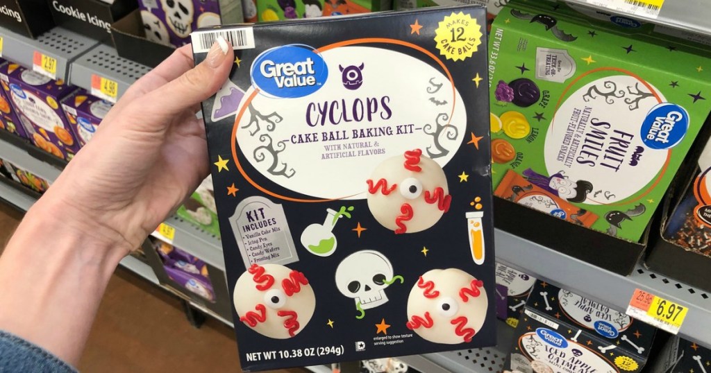 woman holding Great Value Cyclops Cake Ball Baking Kit in Walmart