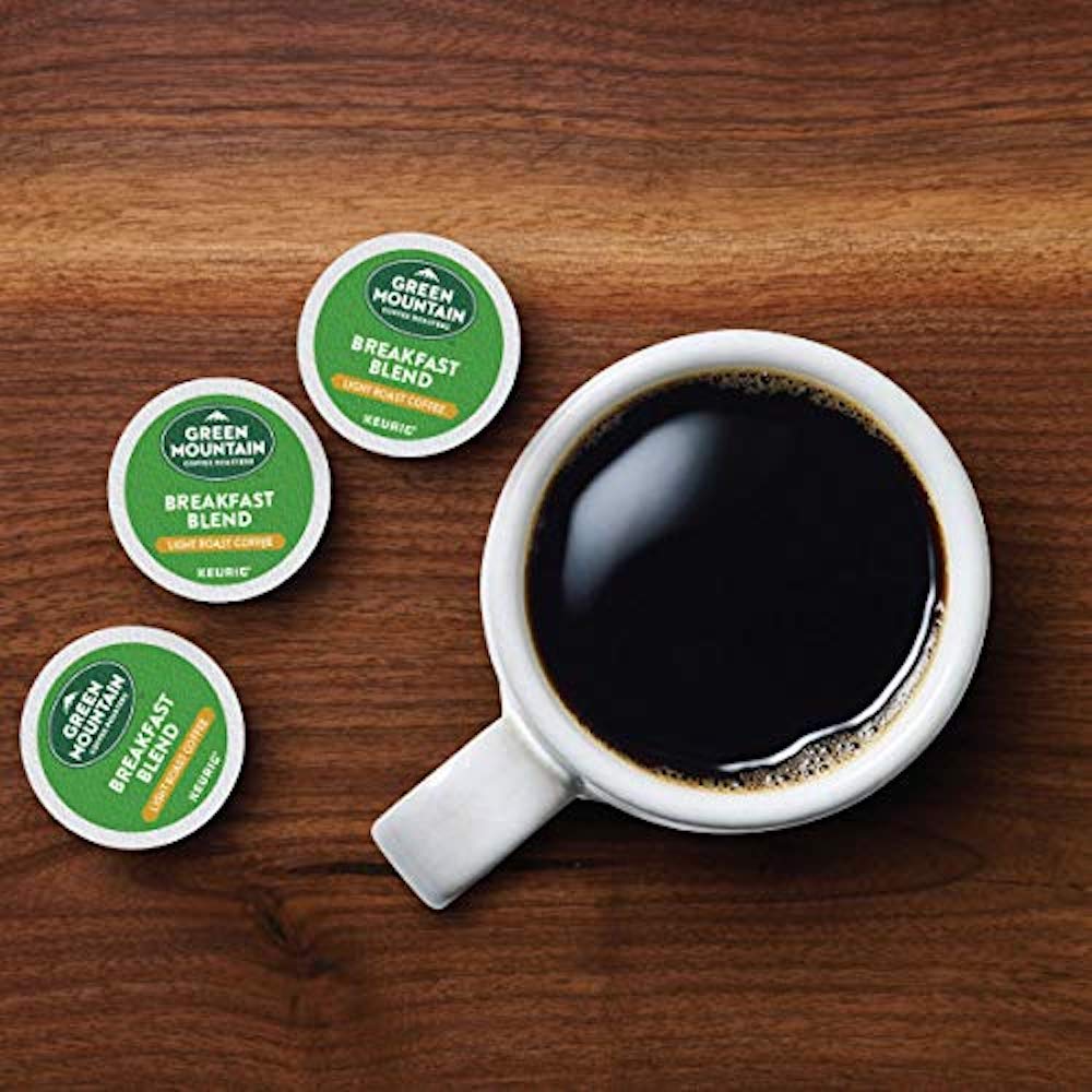 K-Cups next to coffee cup