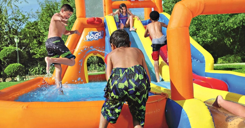 kids playing on inflatable water slide park