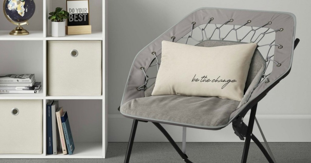 gray hex bungee chair next to bookshelf