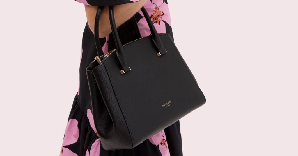 woman holding kate spade satchel