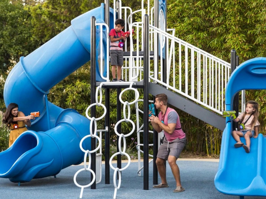 Family playing laser tag at the park