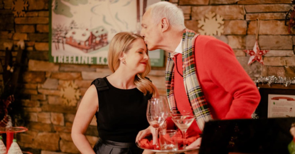Man kissing woman in Christmas movie