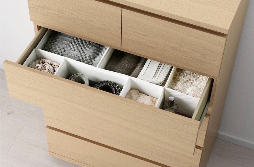 natural wood dresser with organizers and clothes in drawer IKEA