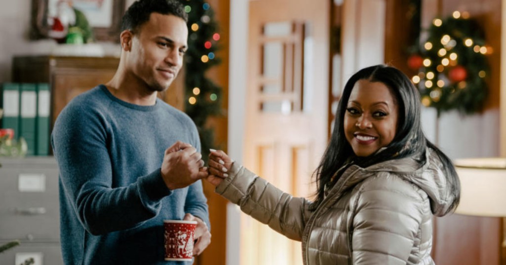 man and woman pinkie promise in Christmas movie