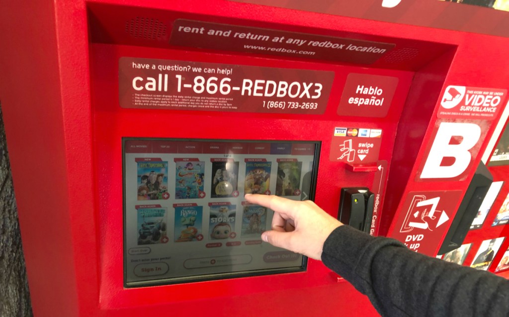 hand touching Redbox screen