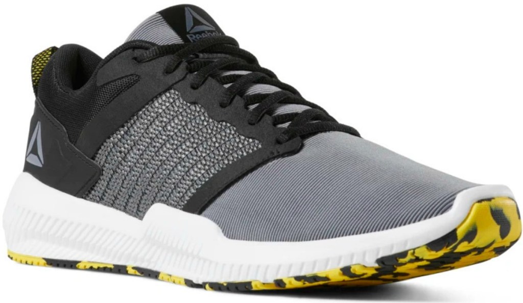 Men's Reebok brand training shoes with yellow and black swirled sole