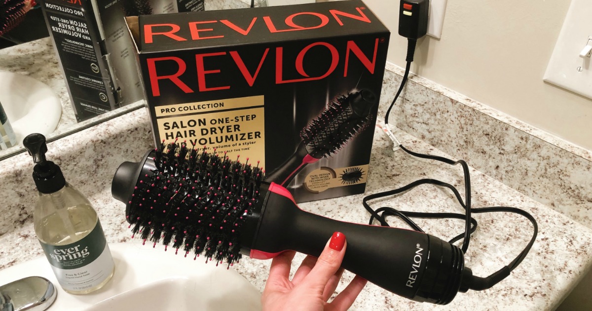 Woman holding Revlon One-Step Hair Dryer &amp; Volumizer