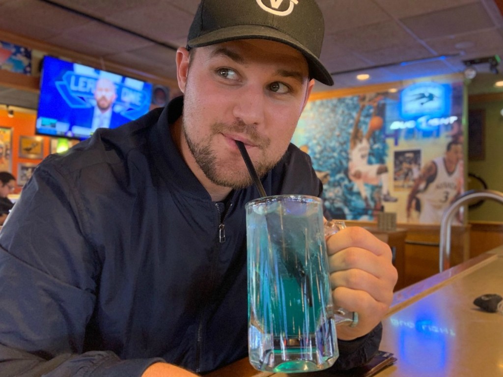 Man drinking Applebees Drink Adios MF in bar