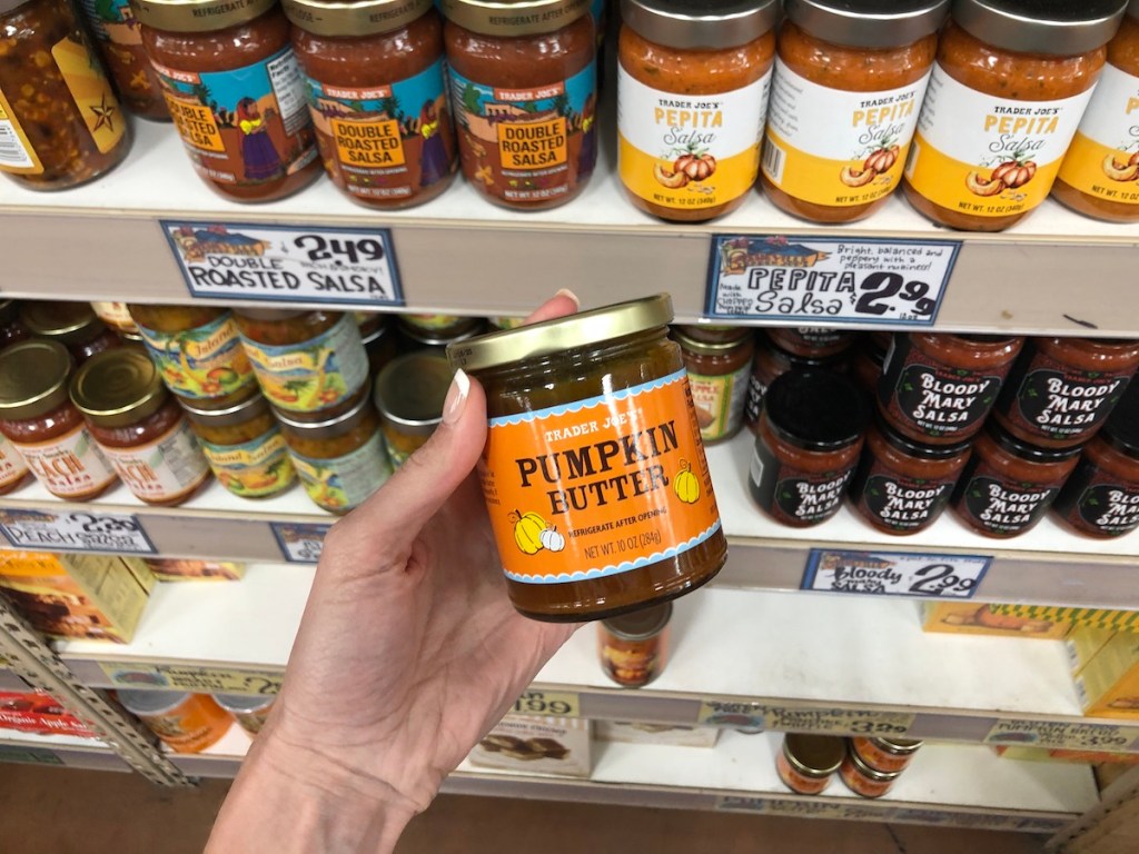 women's hand holding Trader Joe's pumpkin butter in store