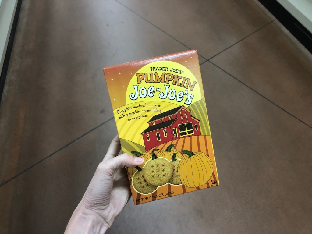 women's hand holding Trader Joe's pumpkin joe-joe's in store