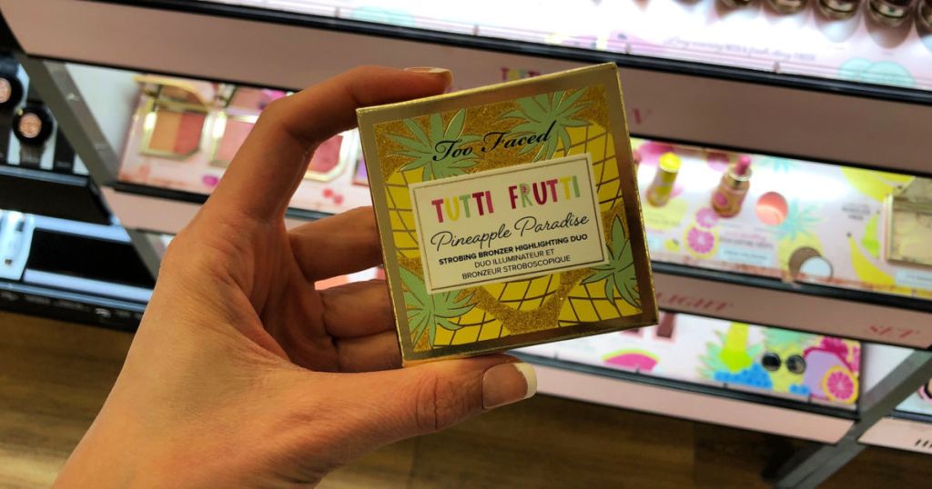 woman hand holding Too Faced Tutti Frutti Pineapple Paradise at Ulta