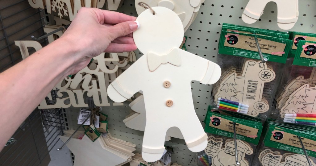 hand holding up wooden gingerbread