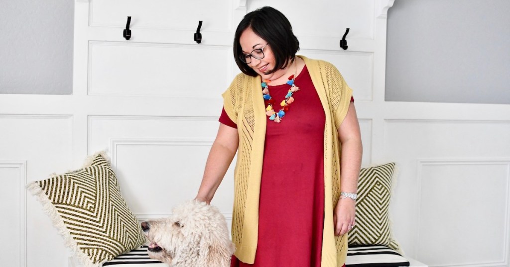 Lina wearing red dress tassel necklace and yellow cardigan