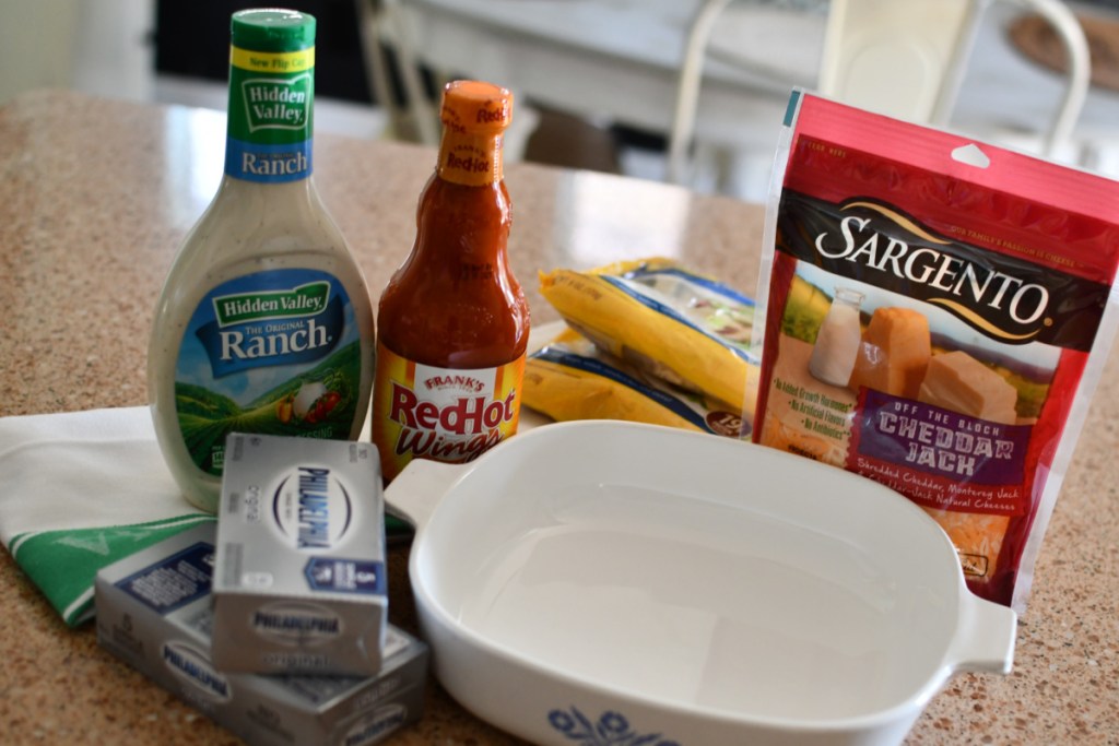 ranch, hot sauce, and cheese by a casserole dish