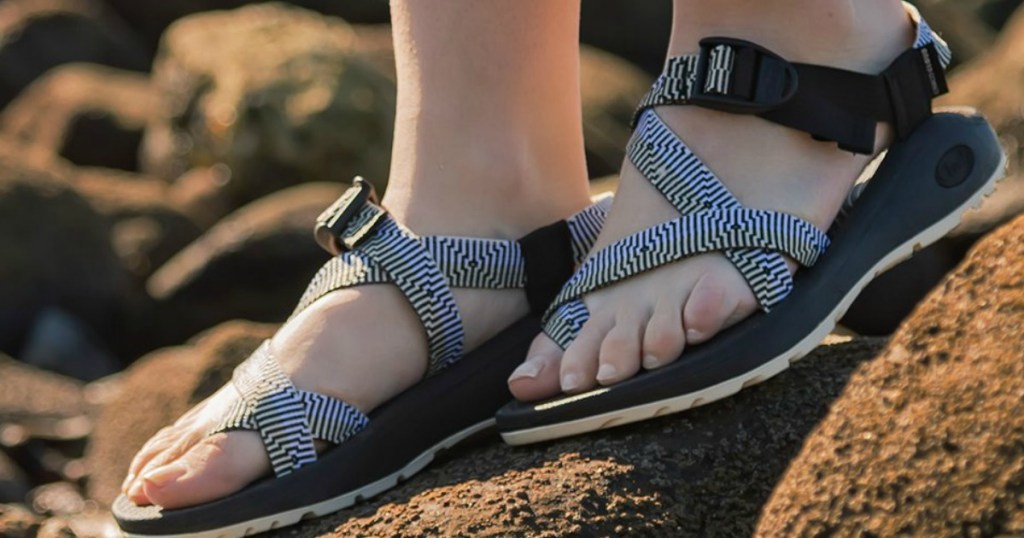 feet with sandles on outside on ground
