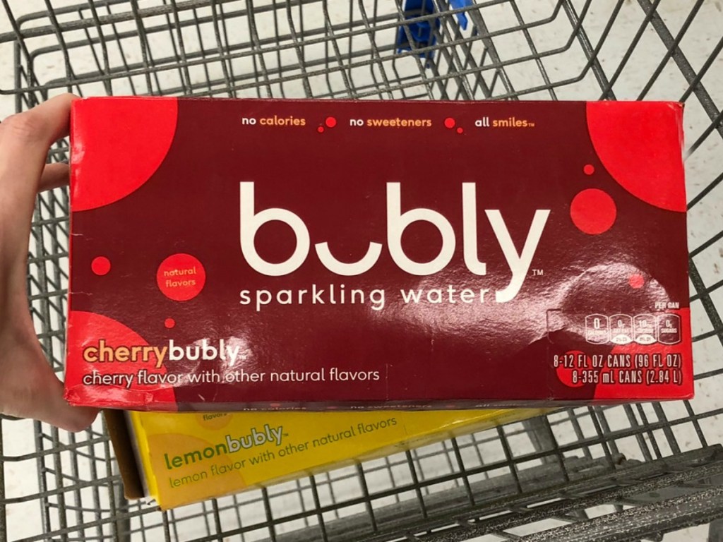 hand holding carton of cans of sparkling water