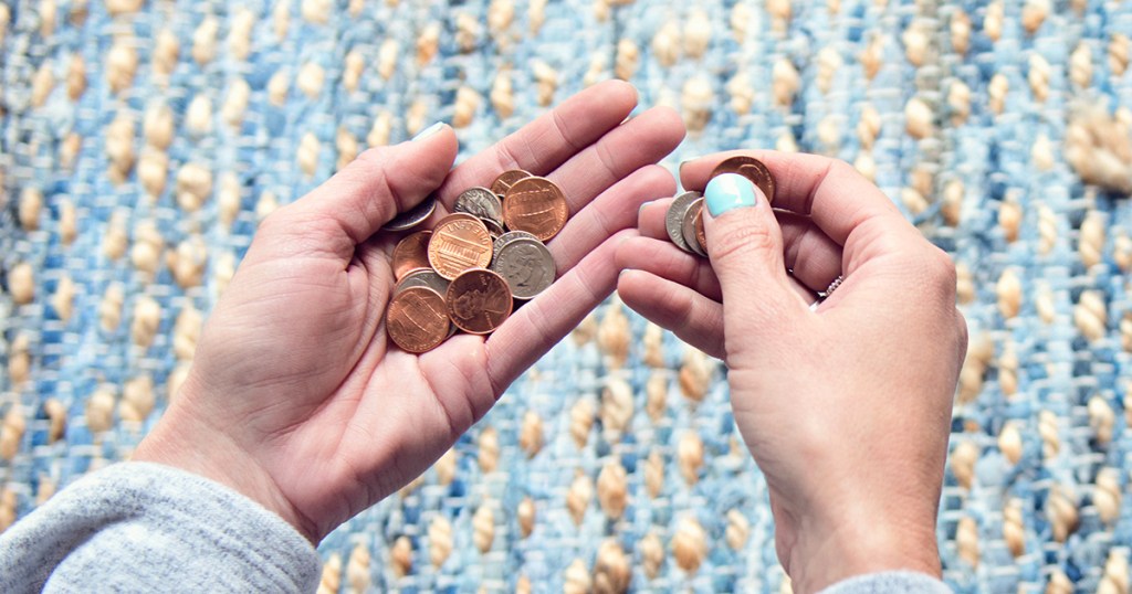 babysitting rates collin's hands holding loose coins and change