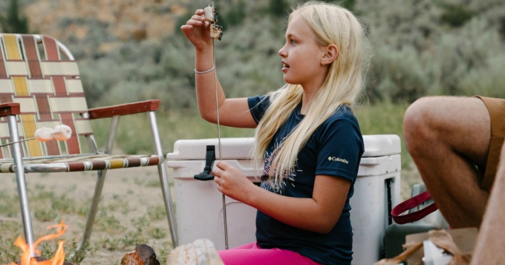 girl making smores camping